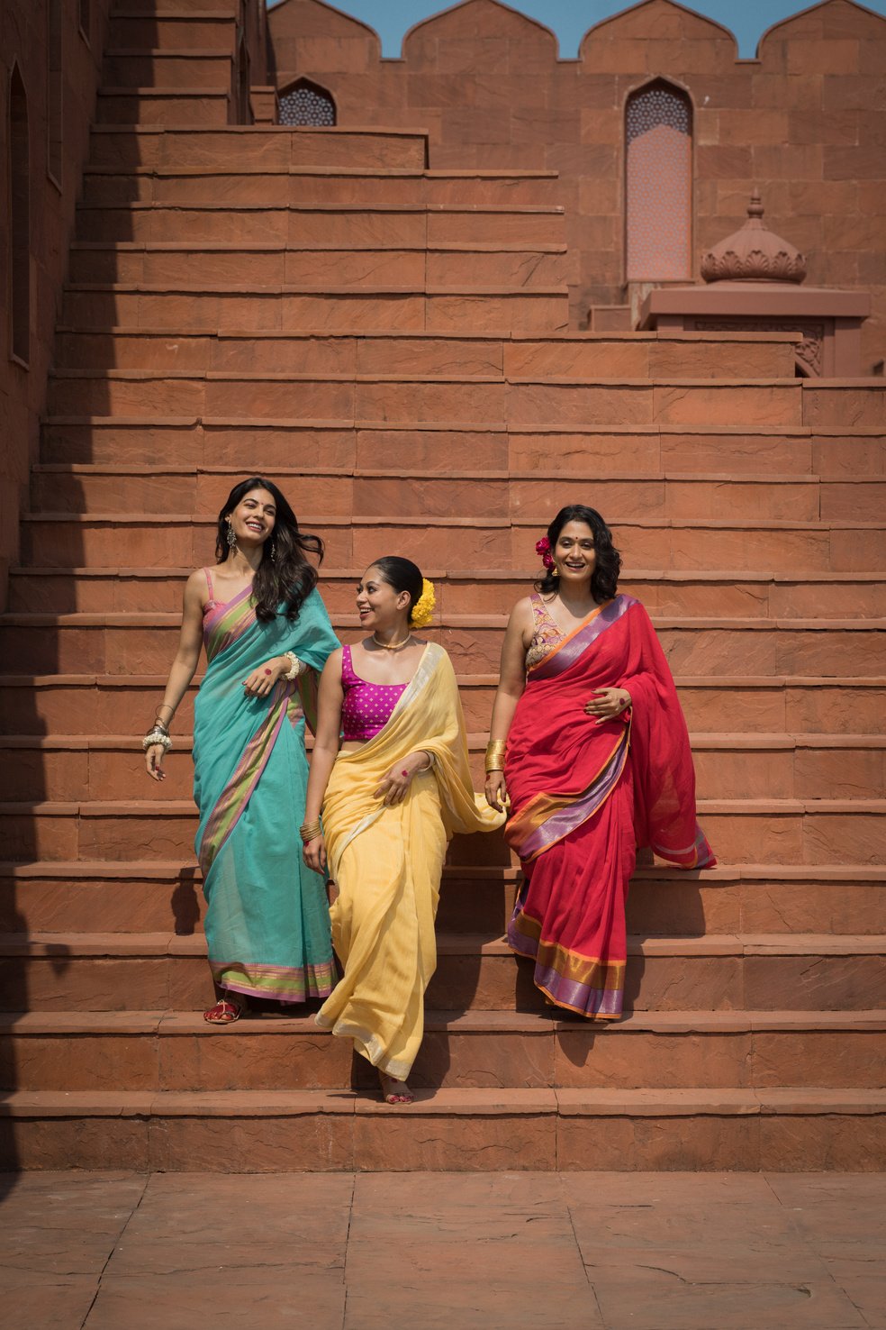 Women Wearing Sarees on a Staircase